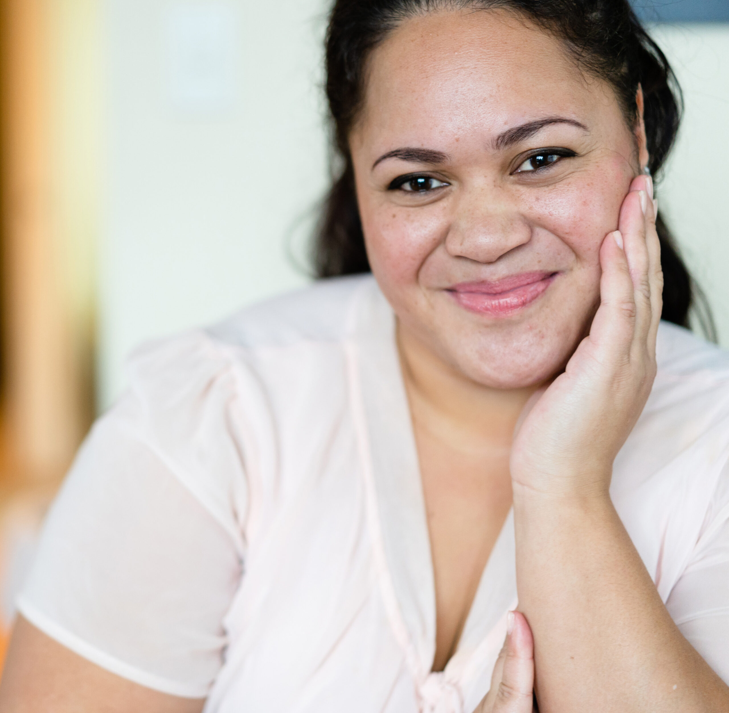 Portrait of happy Maori woman at home.